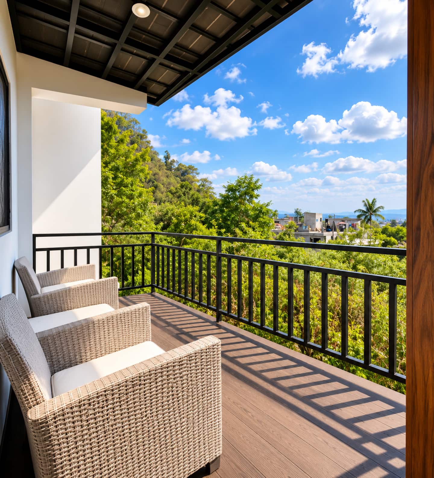 Monarca’s covered private balcony with two armchairs and views toward the volcanoes